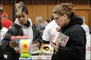 Vivian Myers, left, and Victoria Pasco sort through toys.