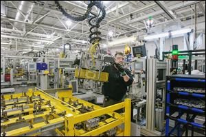 Jeff Roe of Oregon works on a six-speed transmission at GM’s Toledo Transmission plant. In 2009, employment at the plant had fallen to fewer than 500, said Ray Wood, president of United Auto Workers Local 14. Now the Alexis Road plant employs 1,890 people. ‘Our plant is alive and well because of the bailout,’ Mr. Wood said.