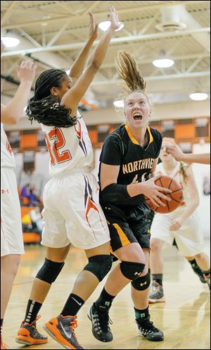 Northview’s Maddie Cole, right, drives past Southview’s Kennedy Moody during the third quarter. Cole had nine points and nine rebounds for the Wildcats in the rivalry contest.