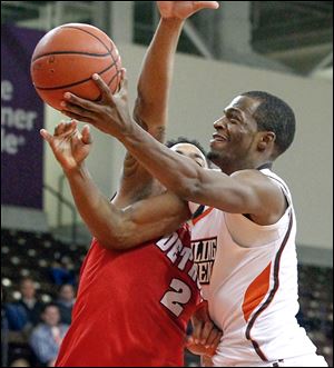 Spencer Parker gets off a shot despite the tight defense from Detroit's Juwan Howard, Jr. 