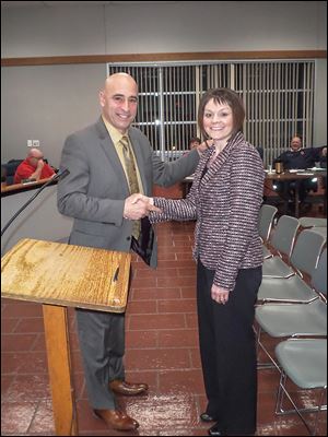 Melissa Purpura of Perrysburg Township shakes hands with Oregon Mayor Mike Seferian. She replaces Paul Goldberg.