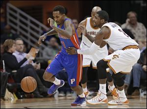 Cleveland Cavaliers' Kyrie Irving, right, fouls Detroit Pistons' Brandon Jennings (7) during the first quarter.