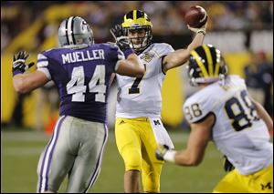 Michigan quarterback Shane Morris (7) throws to teammate Jake Butt (88) as Kansas State defensive end Ryan Mueller (44) defends during the first half of the Buffalo Wild Wings Bowl NCAA college football game on Saturday.