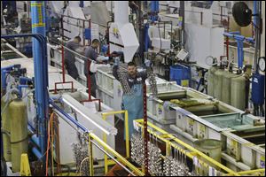 Employees at Sheffield Platers Inc. work on the factory floor in San Diego. 