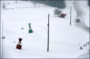 The nearby lawn is blanketed with snow near Boers-Boyer Way on Sunday. The storm dropped 8.2 inches of snow at Toledo Express Airport and generally caused havoc across the region.