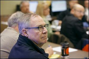 Mayor D. Michael Collins listens during a meeting of public officials at the Streets, Bridges & Harbor Command Center on Central Avenue, concerning the storm.