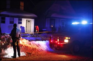 Police investigate a shooting on Colburn Ave. in Toledo, today.