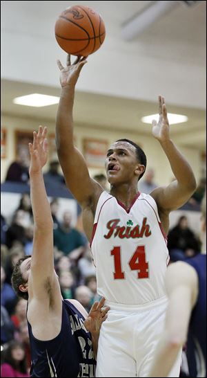 Central Catholic’s DeShone Kizer shoots against St. John’s defender Trevor Walsh on Friday night. Kizer scored 12 of his 29 points after picking up his fourth foul with 6 minutes, 26 seconds left in regulation.