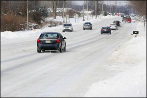 Lewis Ave. near W. Sterns Rd. is covered in snow on Thursday, Jan. 9, 2014.