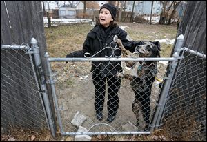 Nancy Schilb speaks with an owner as she pets his dog during an investigation earlier this month.