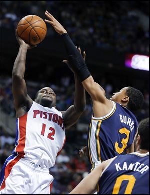 Detroit Pistons guard Will Bynum (12) takes a shot against Utah Jazz guard Trey Burke (3) Friday in Auburn Hills, Mich.