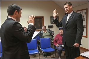 Wood County Commissioner Joel Kuhlman, left, swears in Walbridge Mayor Ed Kolanko on Wednesday at the first city council meeting of 2014. Four council members also took the oath of office. 