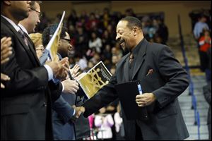 Ray Wood, NAACP President, right, shakes hands with Unity Award Winner Sam Robinson, left, during the MLK celebration.