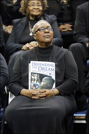 Joan Bolden, with the Toledo Interfaith Mass Choir, holds the program during the celebration at the University of Toledo.