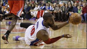 Detroit Pistons forward Greg Monroe passes the ball during the first half today in Auburn Hills, Mich.