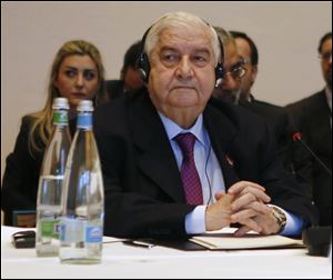 Syria's Foreign Minister Walid al-Moallem leads his delegation during a plenary session in Montreux, Switzerland, today.