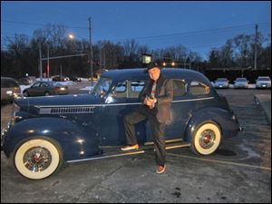 Tom Schwann poses in front of the Packard.