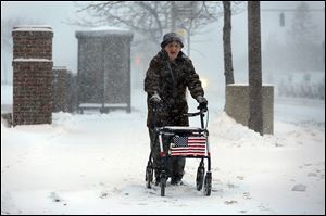 Harold Knapp of Toledo makes his way through the snow downtown, where many residents must walk to bus stops. 