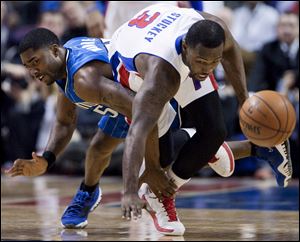 Orlando Magic guard E'Twaun Moore, left, trips up Detroit Pistons guard Rodney Stuckey (3) while chasing a loose ball during the first half.