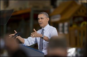 President Barack Obama speaks to Costco employees during a visit to a local Costco in Lanham, Md. 