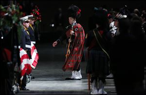 Bagpipers and drummers are led in to  the Last Alarm memorial service at SeaGate Convention Centre for Toledo firefighters Stephen Machcinski and James Dickman.