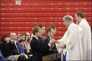 Benjamin Steingass, Daniel Siebenaller, David Nees, and John Kulka, from left, are among eight stu-dents at St. Francis de Sales High School who were ‘knighted’  during ceremonies Friday.