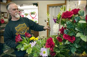 Adrian Brazier, who, with his wife, Jessica, owns Gloria’s Florist in Elmwood Park, N.J. tends to his arrangements. 