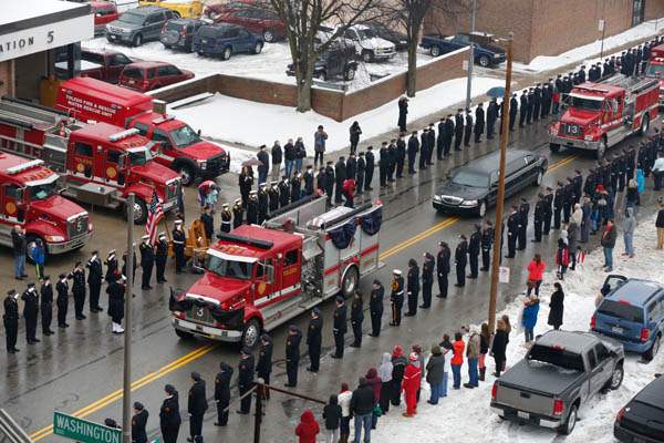 A-Toledo-Fire-Department-truck-carries-a-flag-dra