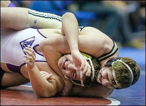 Perrysburg’s Rocco Caywood, top, controls Maumee’s Cahle Paul in the 182-pound final. Caywood won 16-0.