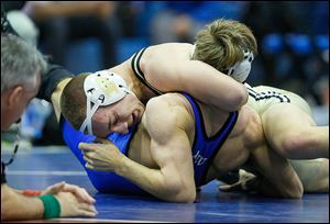 Perrysburg’s J. P. Newton, top, scores back points against Anthony Wayne’s Jimmy Jagodzinski in the 152-pound final. Newton won his fourth straight NLL title.