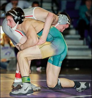 Clay's Gavin Nelson controls the leg of Central Catholic's Josh Mossing in the 138-pound championship match of the TRAC tournament. Mossing won 3-2.