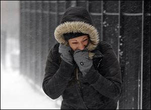 A commuter walk against blowing snow today in Chicago. 