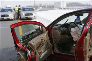 An airbag is sits deflated inside a car at the scene of a wrong-way crash on I-75 southbound near Buck Road today.