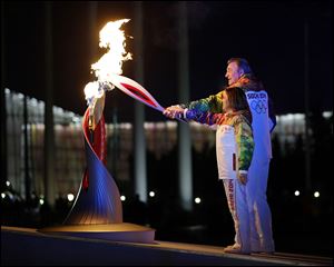 Irina Rodnina and Vladislav Tretiak light the cauldron during the ambitious and large-scale opening ceremony of the 2014 Winter Games in Sochi, Russia.