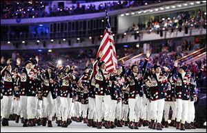 Skier Todd Lodwick of the United States carries the American flag as he leads his team into the stadium during the opening ceremony of the 2014 Winter Olympics.