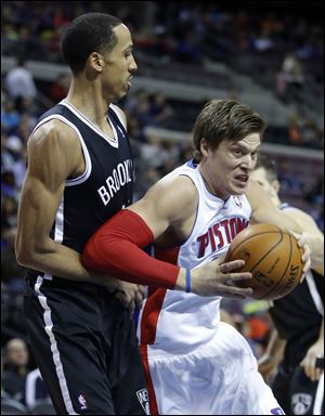 Detroit Pistons forward Jonas Jerebko, right, of Sweden, drives to the basket against Brooklyn Nets guard Shaun Livingston.