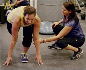 Working mom Regina Camplin works out with health coach Nicole Copare at TV Fitness Pros in Orlando, Fla.