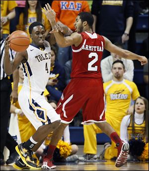 University of Toledo guard Justin Drummond, left, steals the ball from Northern Illinois' Aaron Armstead during a Jan. 21 game at Savage Arena. Drummond is suspended for Wednesday's game against Ohio after being charged with driving under the influence on Saturday night.