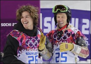 Switzerland's Iouri Podladtchikov, left, celebrates with Shaun White of the United States after  Podladtchikov won the gold medal in the men's snowboard halfpipe final at the Rosa Khutor Extreme Park today in Krasnaya Polyana, Russia. White did not medal.