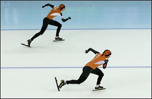 Margot Boer of the Netherlands, top, and Laurine van Riessen of the Netherlands compete in the second heat of the women's 500-meter speedskating race.