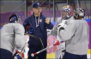 U.S. coach Dan Bylsma, center, talks to his three goalies during a practice session in Russia. Bylsma played four seasons at BGSU.