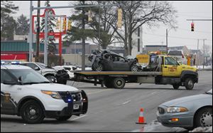 Cars are hauled away from the intersection of Dorr and Byrne streets.