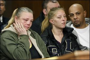 Tracy Bishop, left, and Patricia Rollins, center, who lived at the North Toledo apartment building where two Toledo firefighters were killed while battling a fire, attend the arraignment of Ray Abou-Arab on Feb. 3 in Toledo Municipal Court.