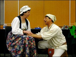 Genot Picor, a historical re-enactor, performer, and storyteller, talks to another historical interpreter as he prepares for the upcoming celebration at River Raisin National Battlefield Park on Saturday.