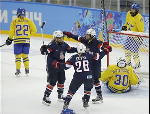 Brianna Decker, left, Kendall Coyne, and Amanda Kessel celebrate a goal by Decker against Sweden during the third period.