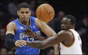 Orlando Magic's Tobias Harris, left, and Cleveland Cavaliers' Luol Deng watch the ball during the first quarter.