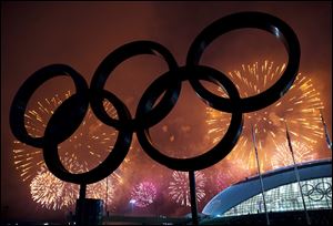 The Olympic Rings are silhouetted as fireworks light up the sky during the closing ceremonies at the 2014 Sochi Winter Olympics on Sunday in Russia.