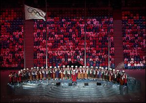 Performers sing on stage before the start of the closing ceremony.