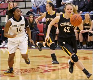 Notre Dame junior Kyndra Gaines (14) and Northview junior Lauren Roth (42) chase down a loose ball in the fourth quarter of their Division I district semifinal match up at Central Catholic.