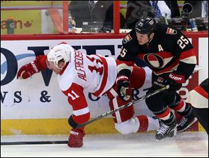 Ottawa Senators' Chris Neil (25) checks Detroit Red Wings' Daniel Alfredsson (11) during second period.